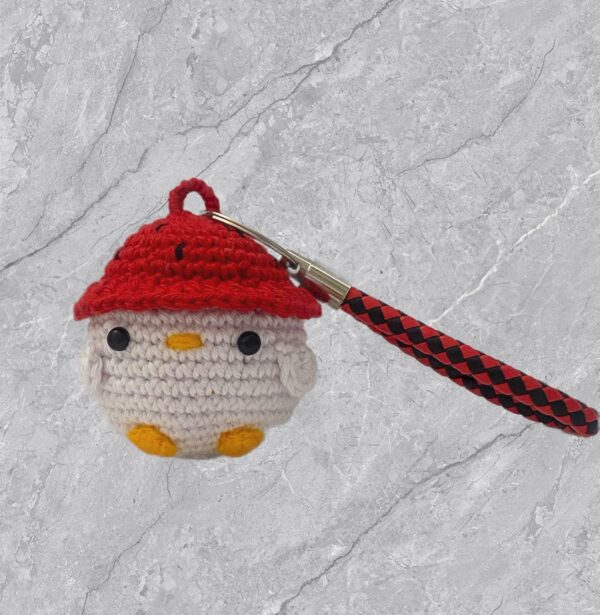 Llavero de pollito con gorrito de fresa a crochet.